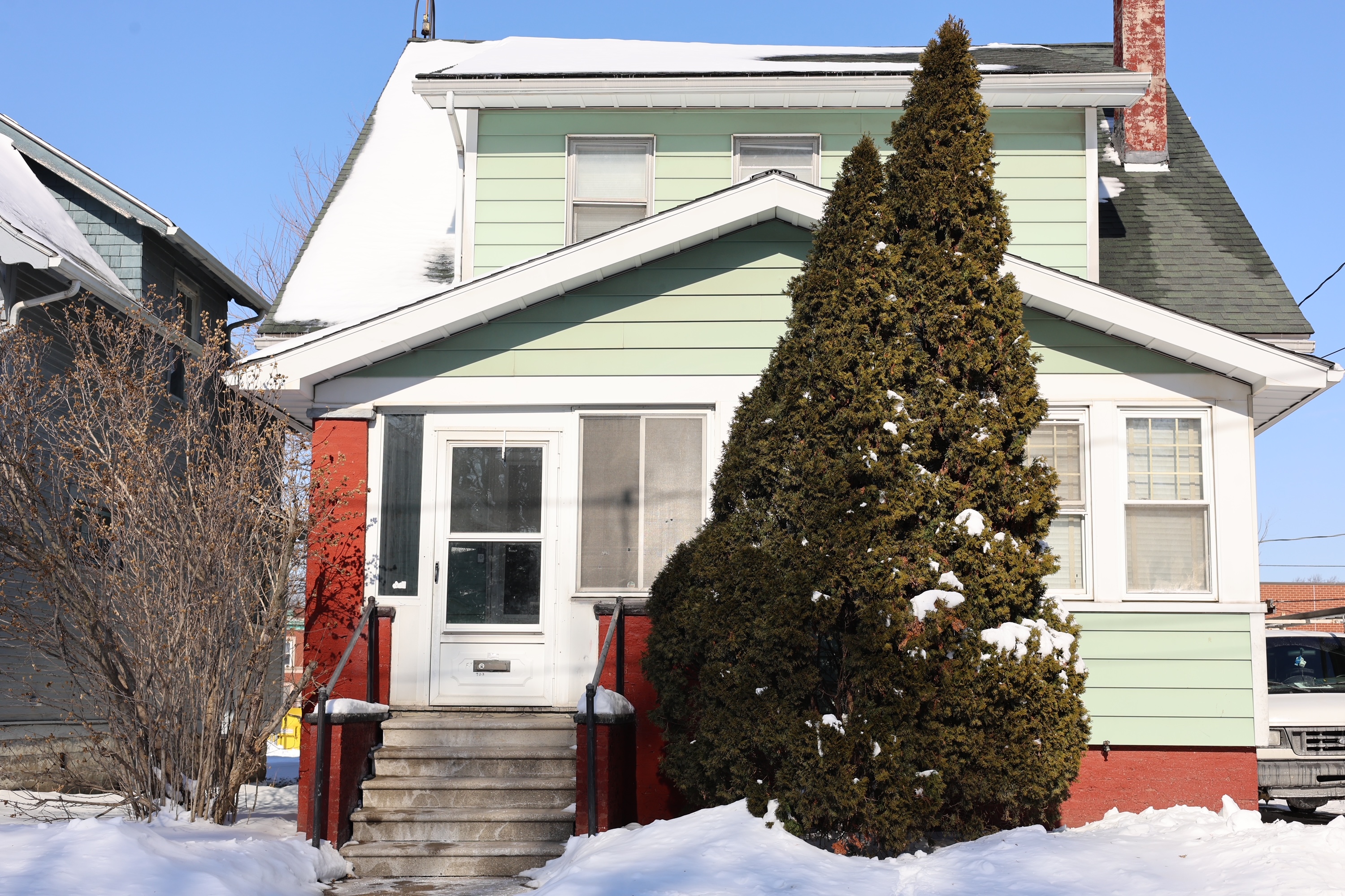 Tiffin house exterior - green two-story home